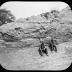 Section of clay bank and laborers at brickmaking facility.