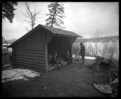 Mr. Houghton and Mr. Carpenter and another man outside lean-to