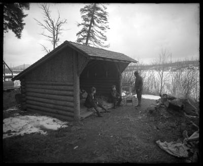 Mr. Houghton and Mr. Carpenter and another man outside lean-to