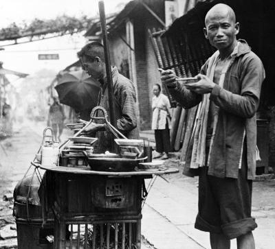 Patronizing a traveling restaurant, chair laborer eating rice and fish, Canton, China