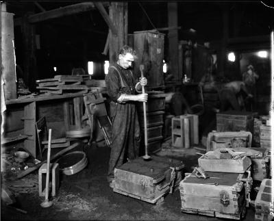 Labor.  Man Setting Green Brick.