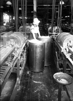 Woman pulling hampers at International Harvester Company