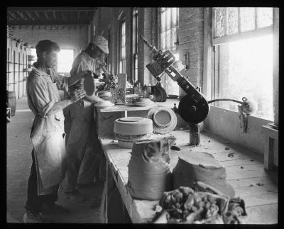 Plate and Saucer Making; a Jigger and a Bat Making Machine in Operation. Iroquois China Co., Syracuse, N.Y.