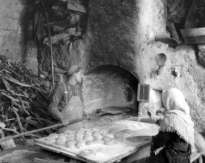 Syria.  Village Baker, Bread Ready for Oven, Woman Helper.  Lebanon